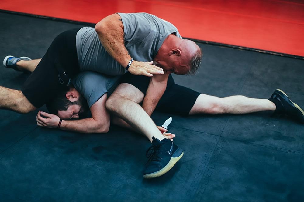 Ground-defense drill against an edged-weapon attack in a self-defense class