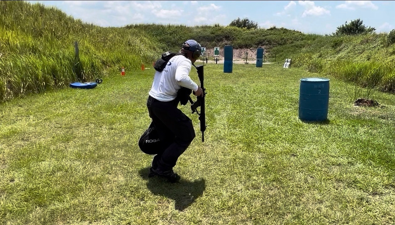 Shooter moving between barrels during a high heart rate carbine stress drill